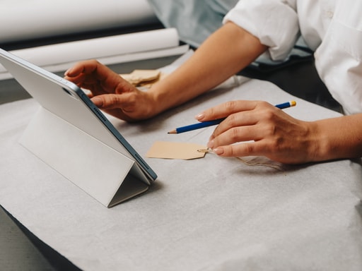 Person reviewing plans on a tablet at a desk